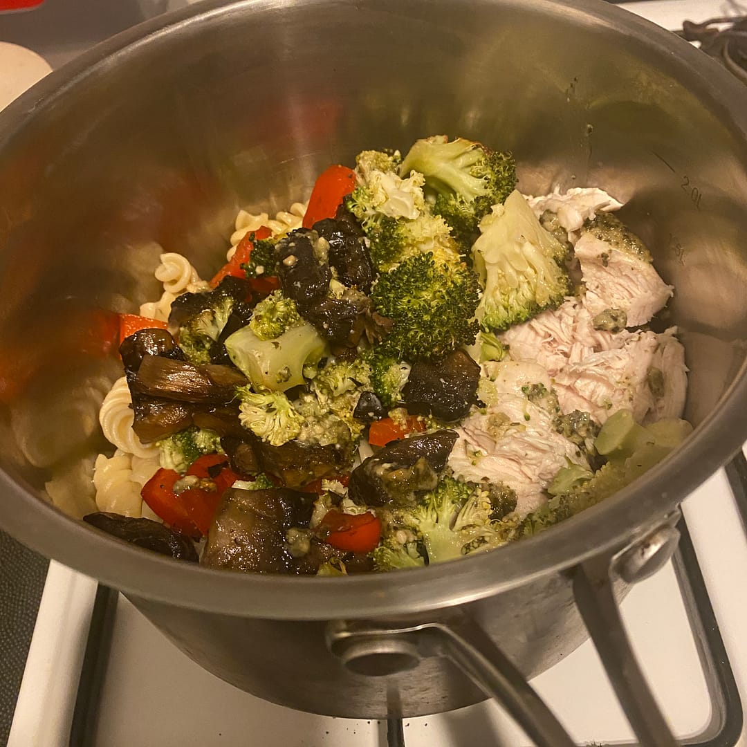roasted veggies and chicken with pasta in a saucepan