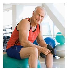gentleman sitting on exercise ball with weights