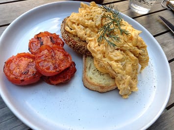 Scrambled eggs and grilled tomato
