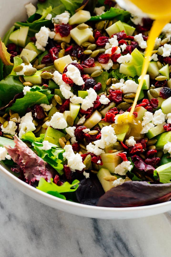 green salad with apples, pepitas cranberries and goats cheese