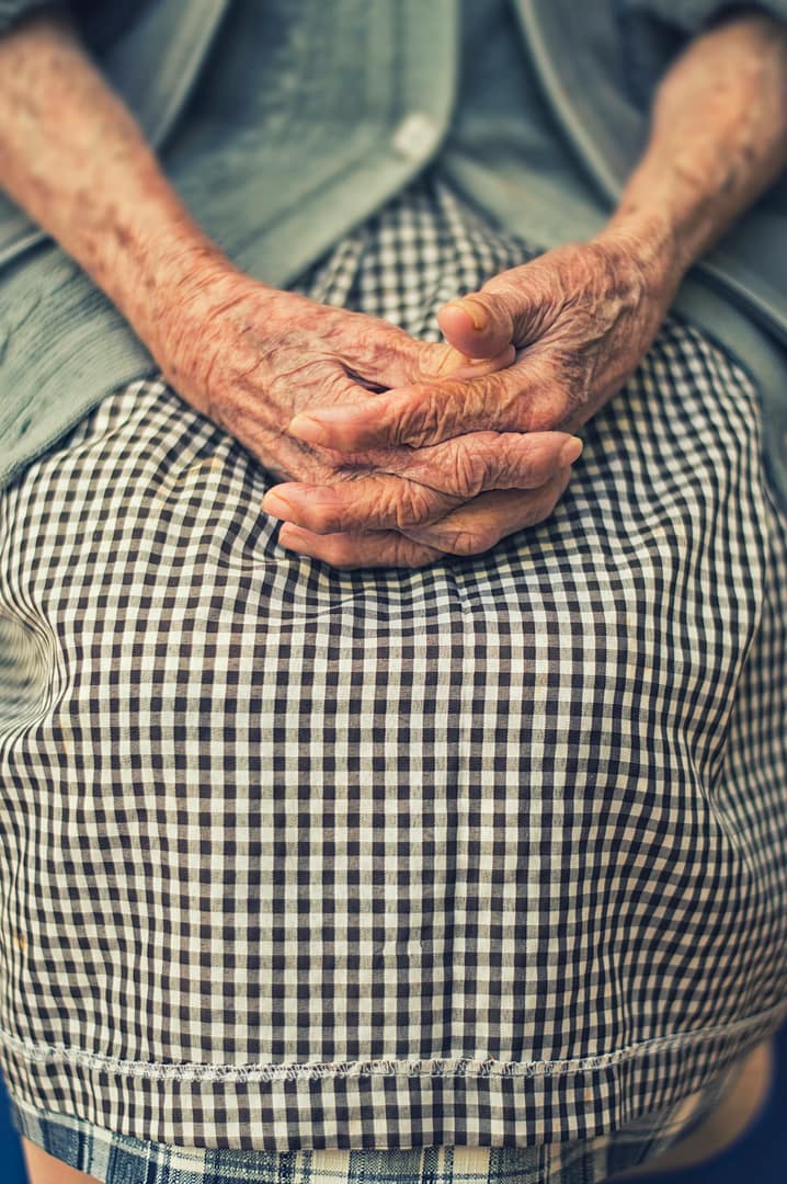 eating for longevity - what would ally do? - an elderly woman's hands in her skirt