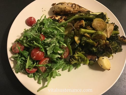 plate filled with veges and salad and a little roast chicken